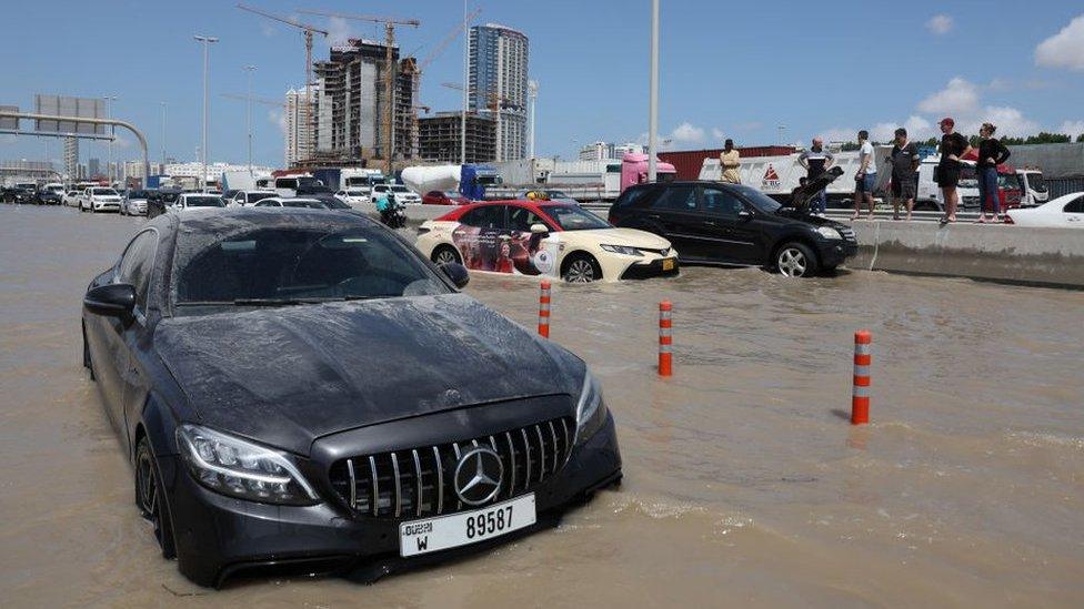 car stranded in flood waters in dubai