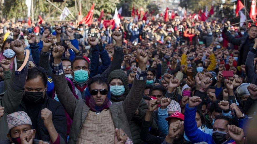 Nepalese Communist activists hold up their fists during a protest against the dissolution of parliament in Kathmandu, Nepal