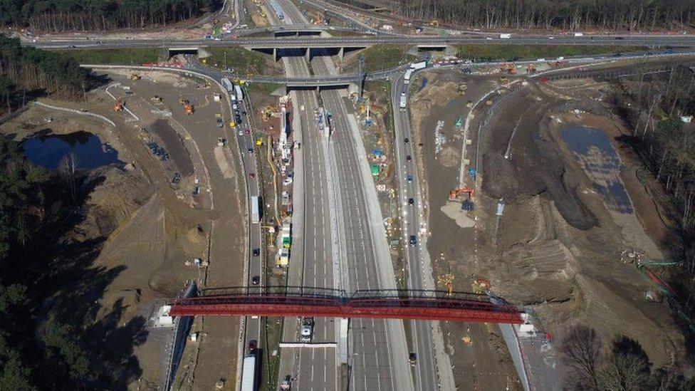 A red metal structure is in place over the closed M25