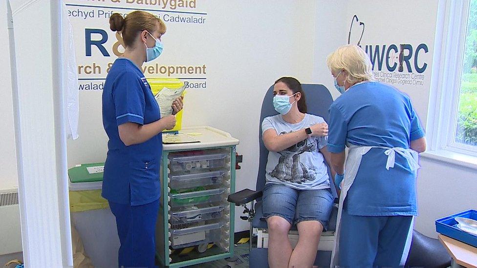 a volunteer is given a Covid booster vaccine at the Wrexham trial