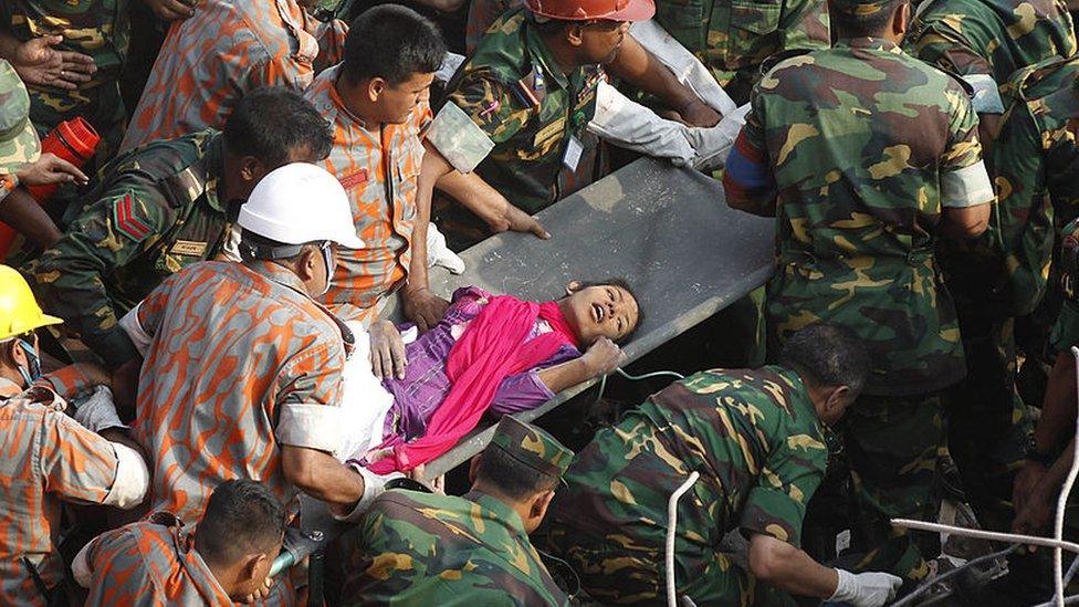 Bangladeshi rescuers retrieve garment worker Reshma from the rubble of a collapsed building