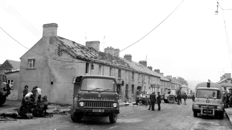 clean up in the Co Londonderry village of Claudy on July 31, 1972, after three car bombs exploded