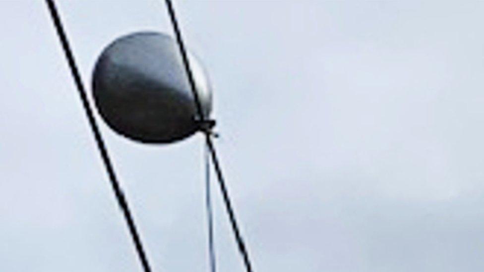Helium balloon caught on overhead electric cables in Manchester