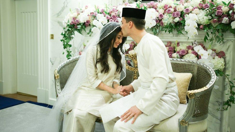 Dennis Muhammad kisses the forehead of his wife Johor Princess Tunku Tun Aminah