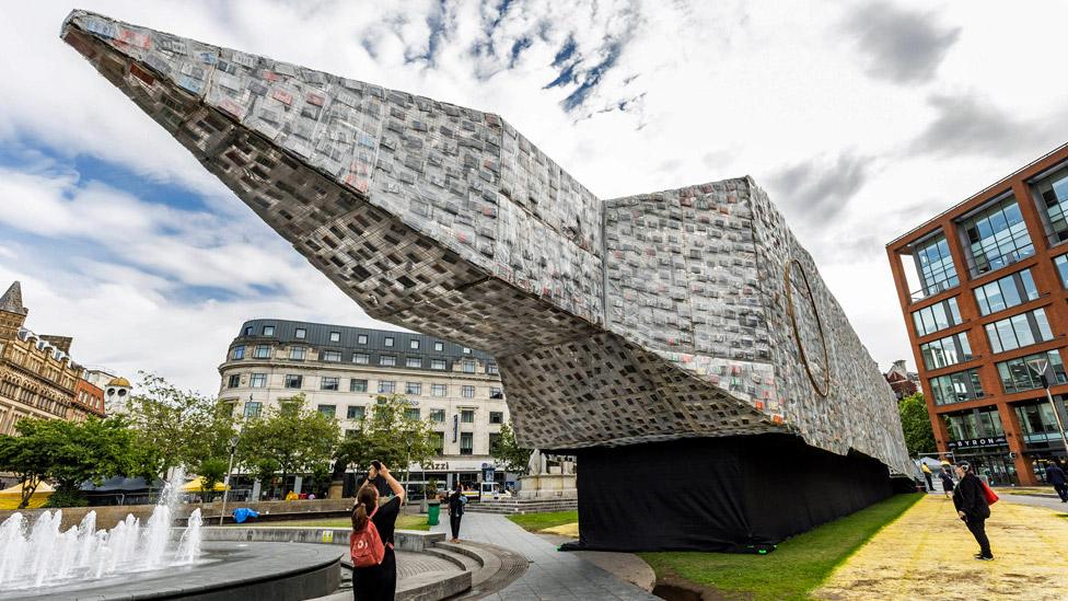 Marta Minujin's Big Ben Lying Down With Political Books