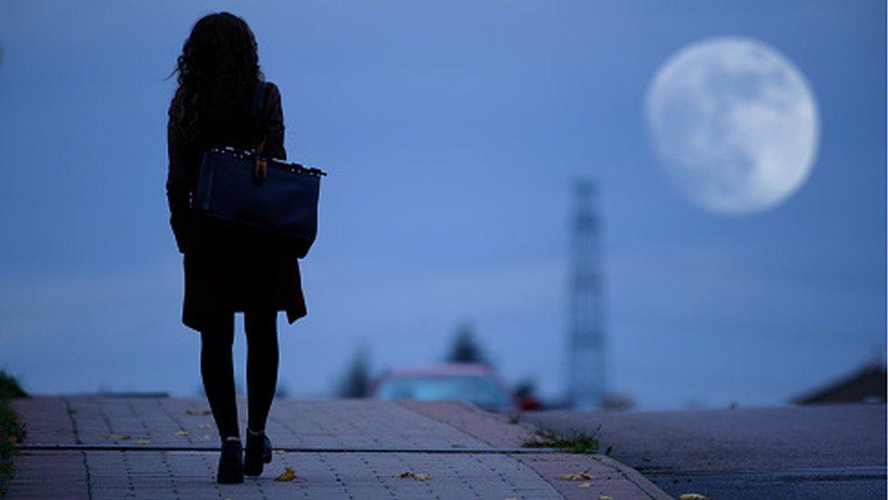 Young woman walking home alone