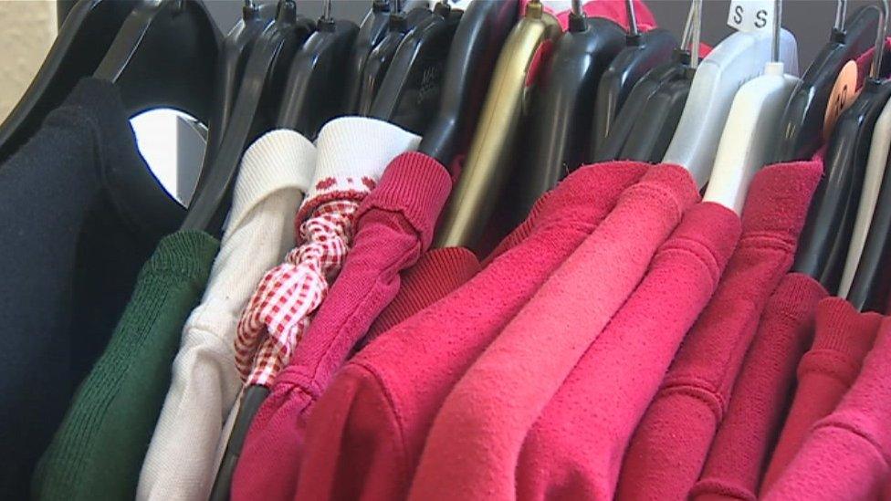 School uniforms hanging on coat hangers