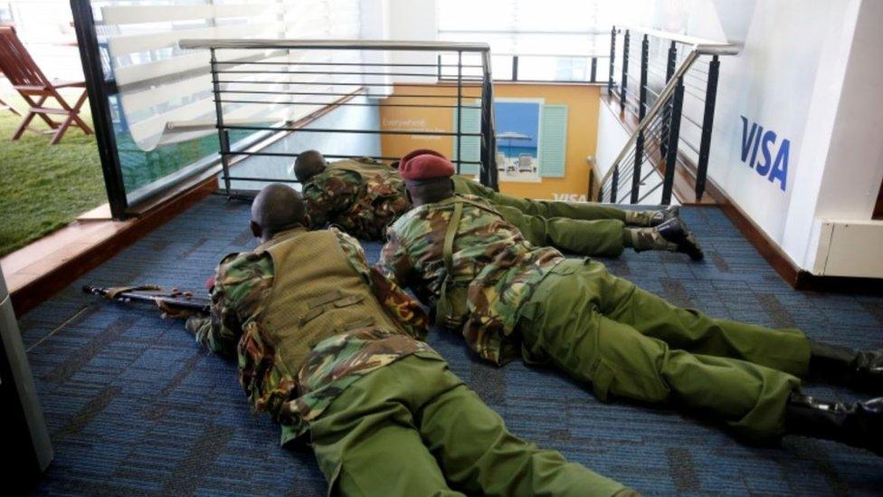 Members of security forces secure a building at the scene where explosions and gunshots were heard at the Dusit hotel compound, in Nairobi, Kenya January 15, 2019.