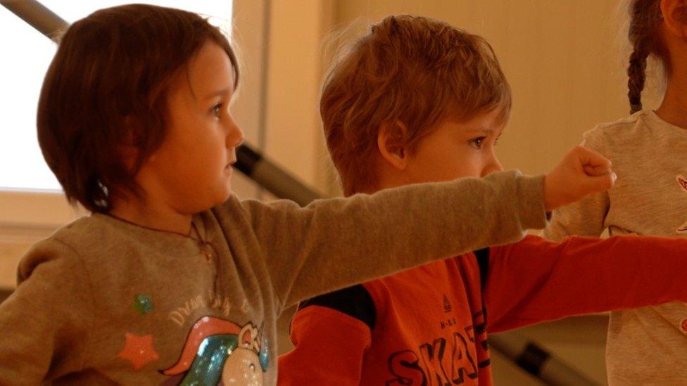 Ukrainian children take part in a karate class for new arrivals in eastern Poland