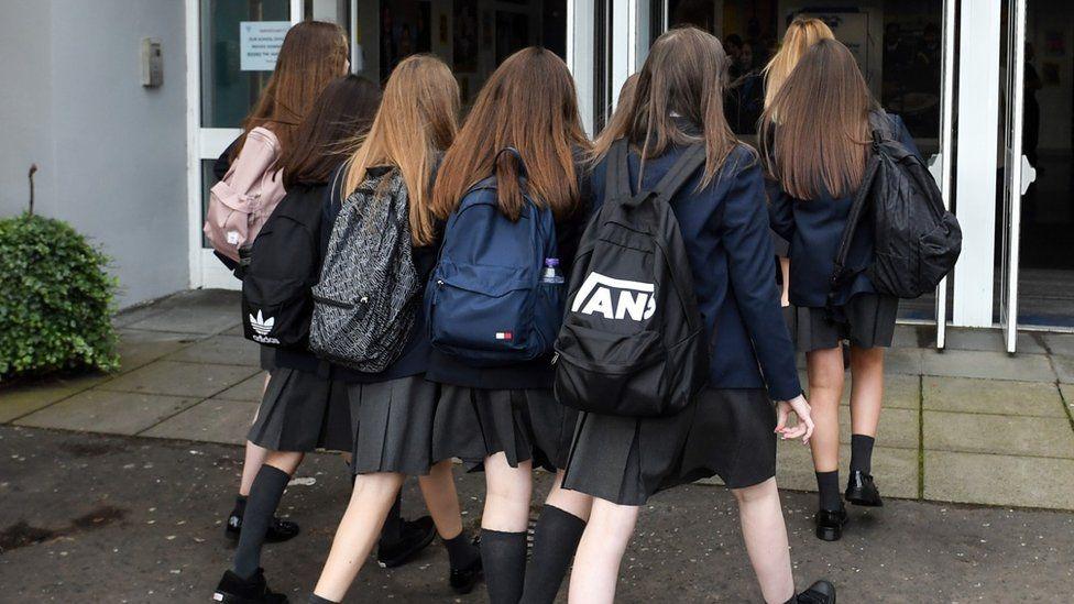 School pupils walking into a school