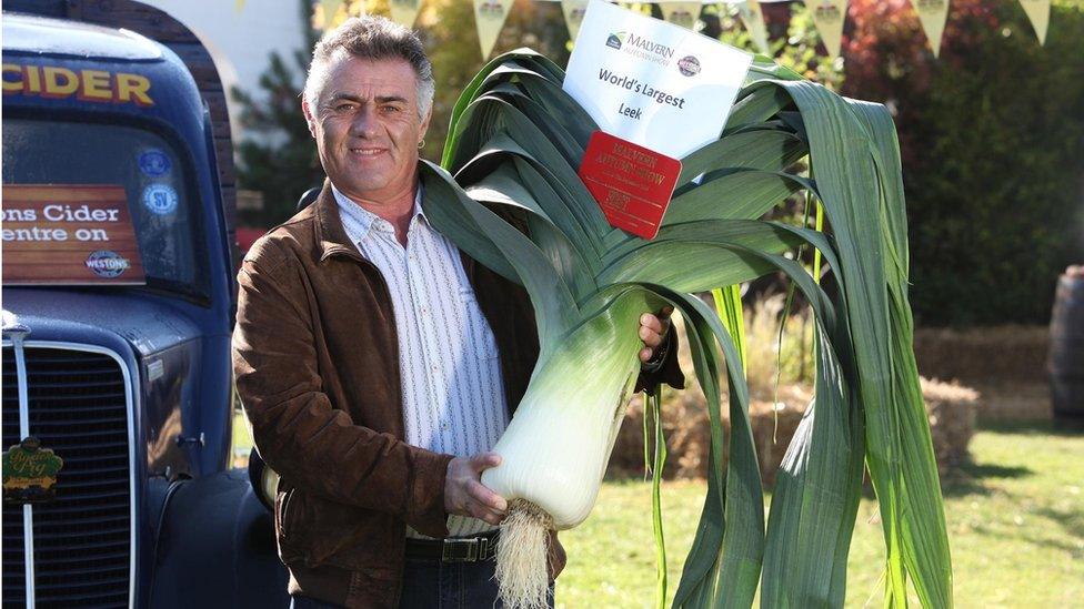 Man holding giant Leek