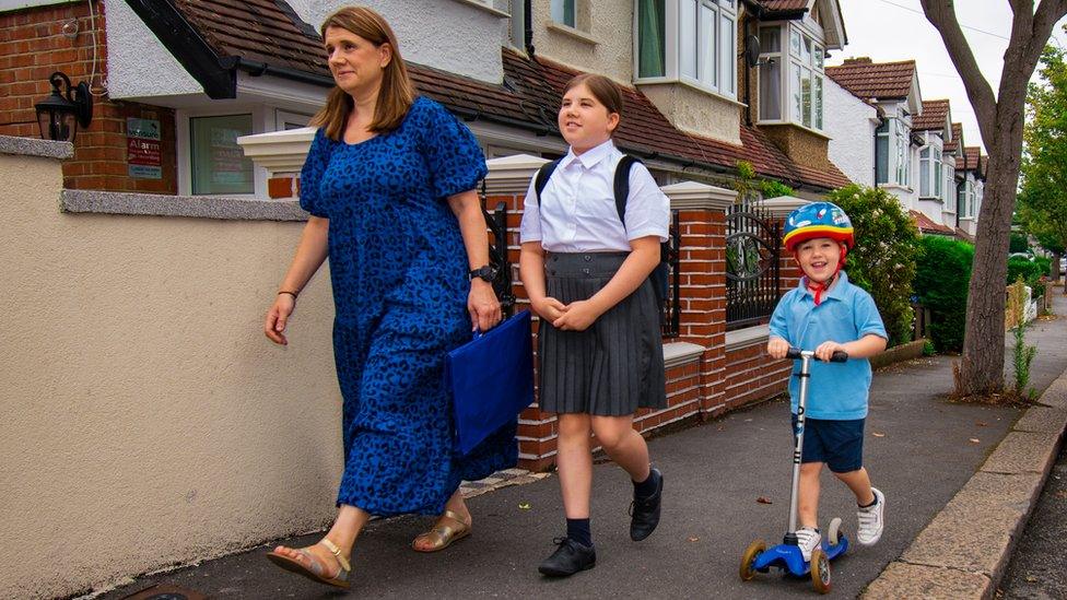 A pupil going to school on a scooter