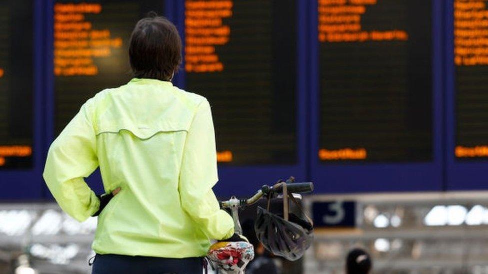 Passenger scans train departures board