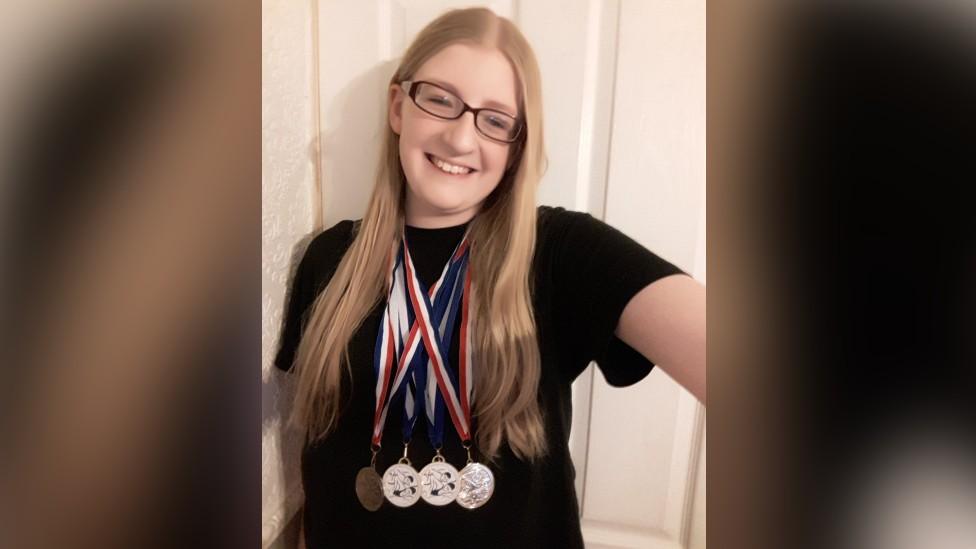 Katie Mahers with the medals she has won for Phoenix Swimming Club for Disabled