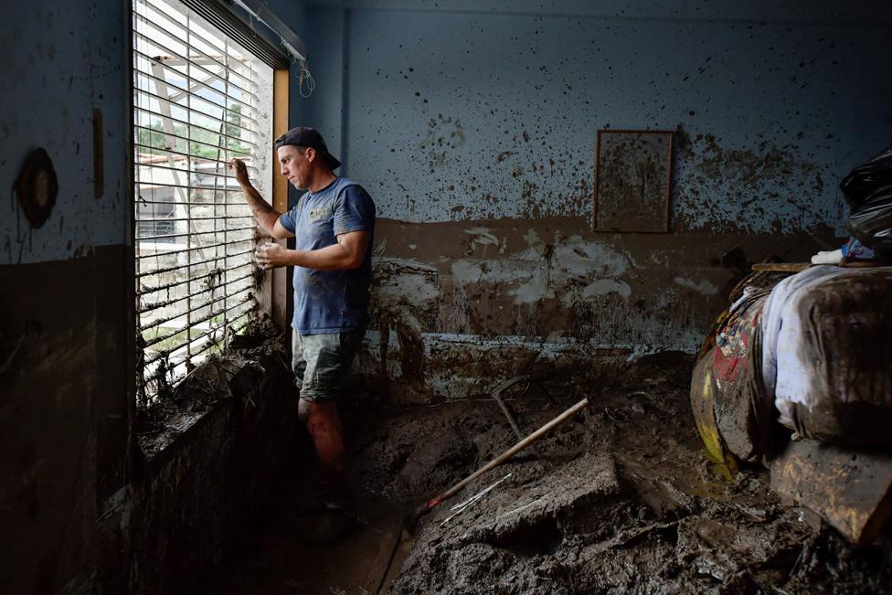 Juan Figalo looks out the window of what was left of his bedroom in the neighbourhood of El Castano, in Maracay, Aragua state, Venezuela, 18 October 2022