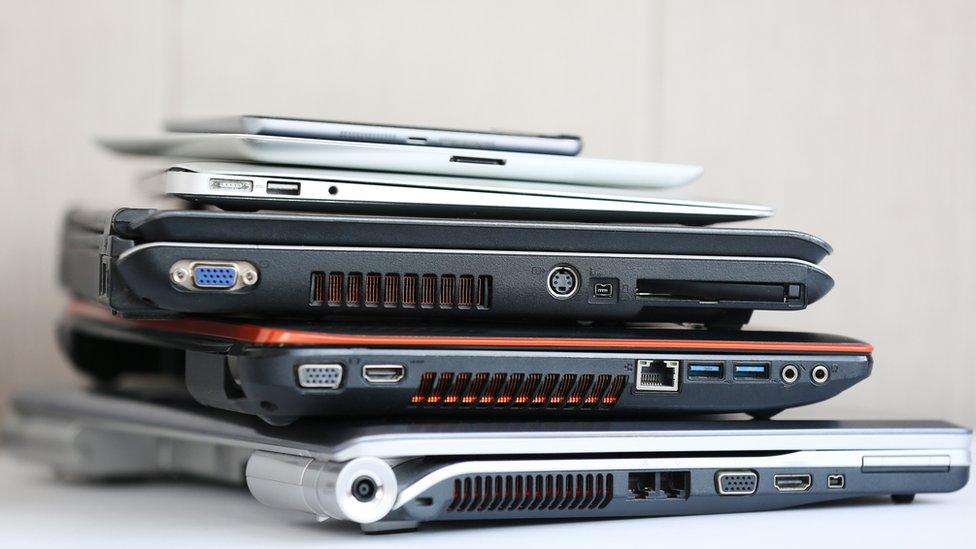 laptops and tablets piled up