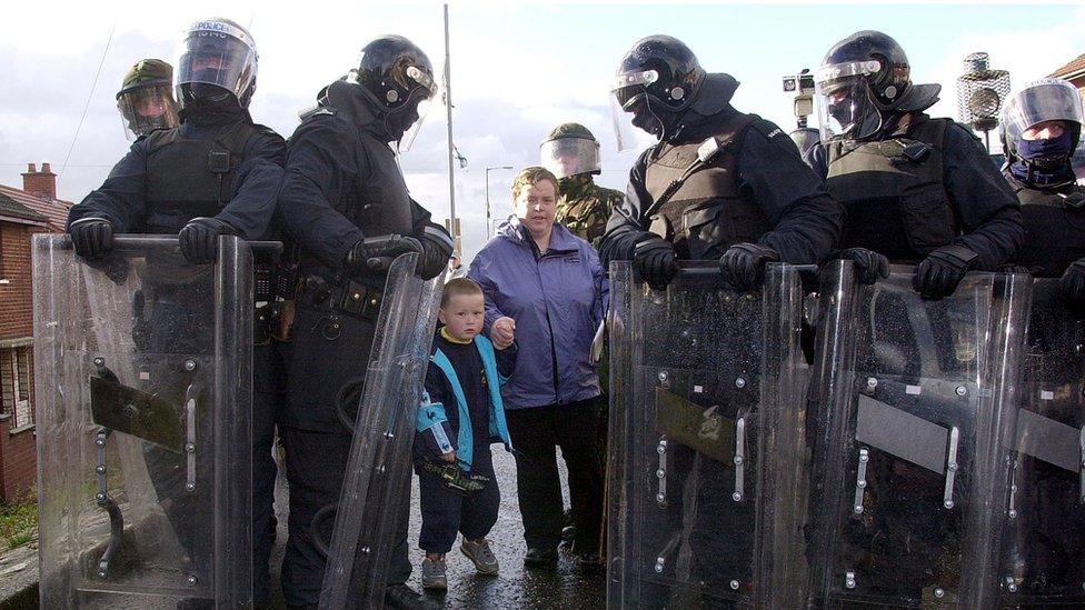 Armed police officers escorted the children and their parents to the school until the dispute was resolved in 2001