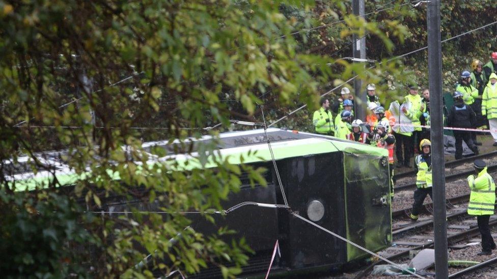 Firefighters are working to free two people who remain trapped in the tram