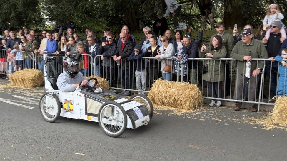 A man driving a white go-kart