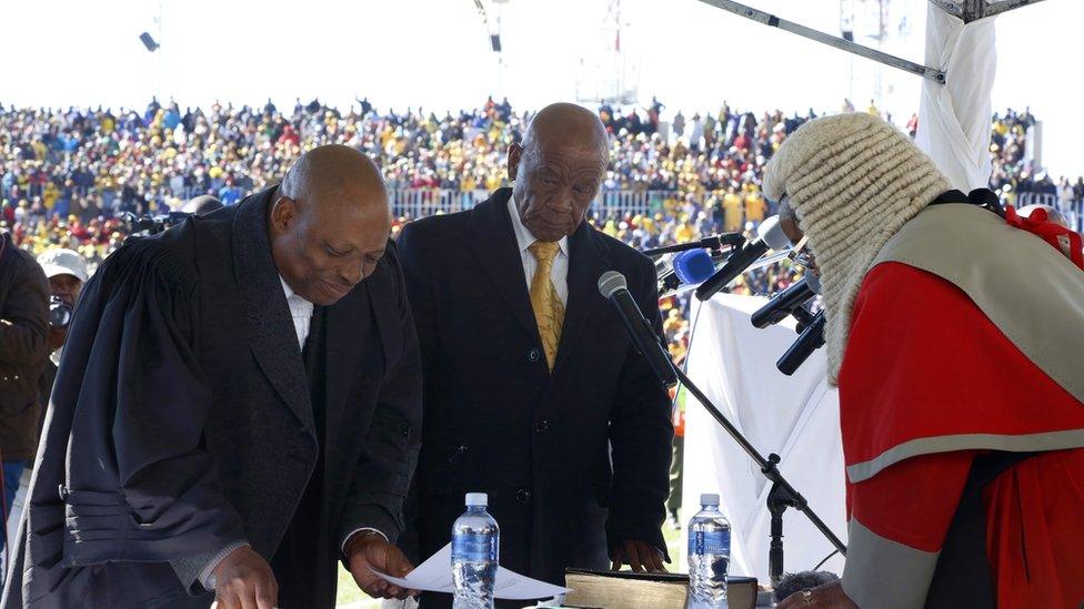 Newly appointed Lesotho prime Minister Thomas Thabane (L), leader of the All Basotho Convention (ABC) political party, is sworn in on June 16, 2017 in Maseru. Lesotho"s new prime minister took office at the head of a coalition government, three years after he was targeted by a putsch and two days after the murder of his estranged wife