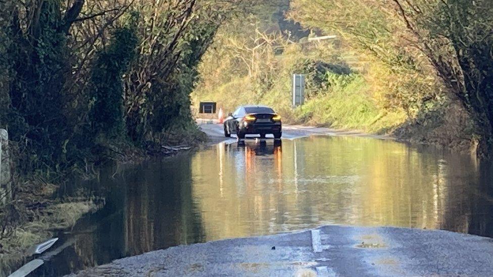 A car at flooded Barking Road