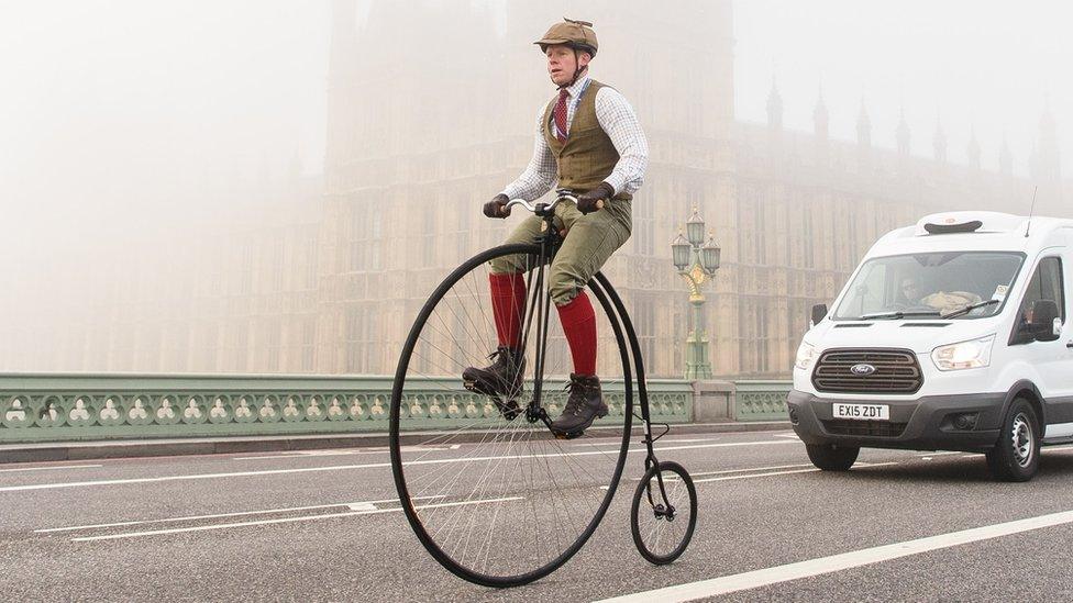 A man riding a Penny Farthing bike