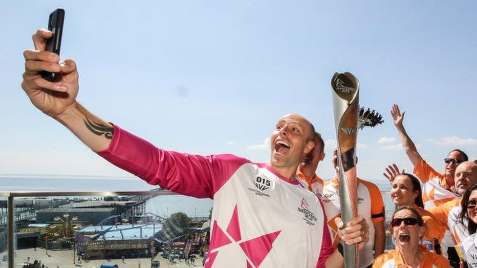 Baton bearer Dean Macey holds the Queen's Baton during the Birmingham 2022 Queen's Baton Relay on a visit to Southend-on-Sea