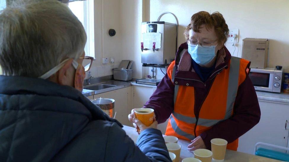 Volunteer serving coffee