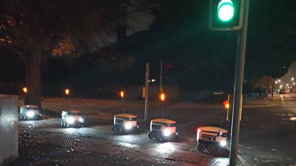 Robots queuing to cross a road in Cambridge