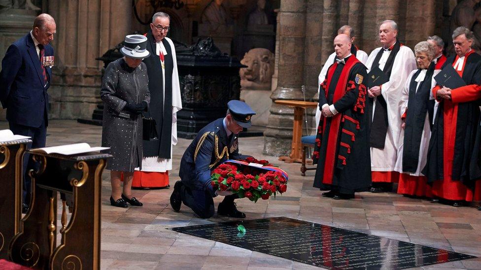 A member of the RAF laying a wreath on the tomb of the Unknown Soldier in Westminster Abbey.