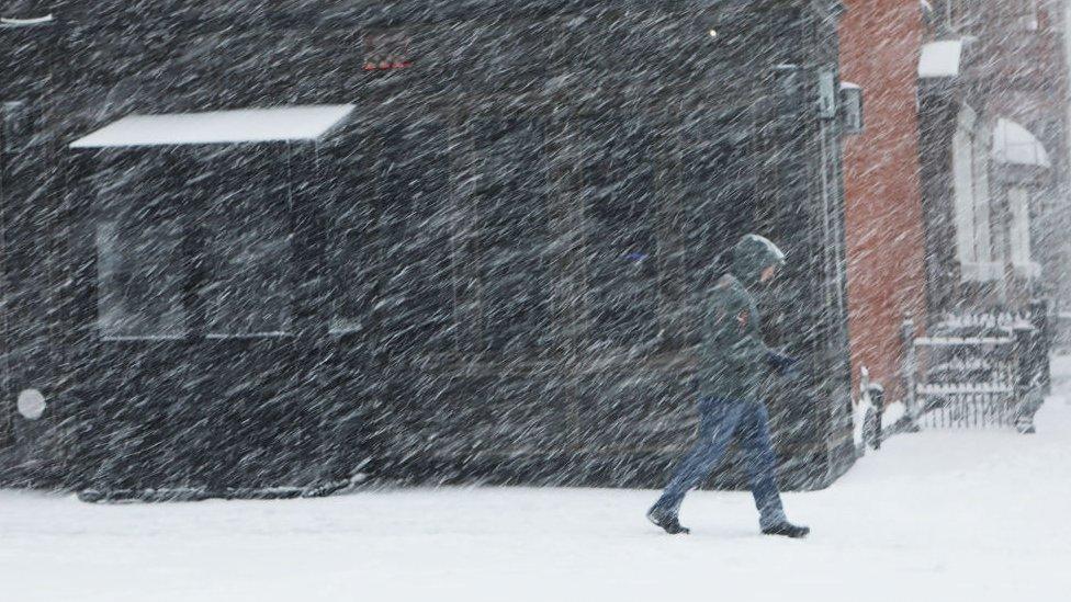 A pedestrian in Brooklyn braves heavy snow