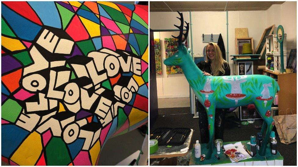 Colourful design saying "Love" and artist with picture with her green reindeer