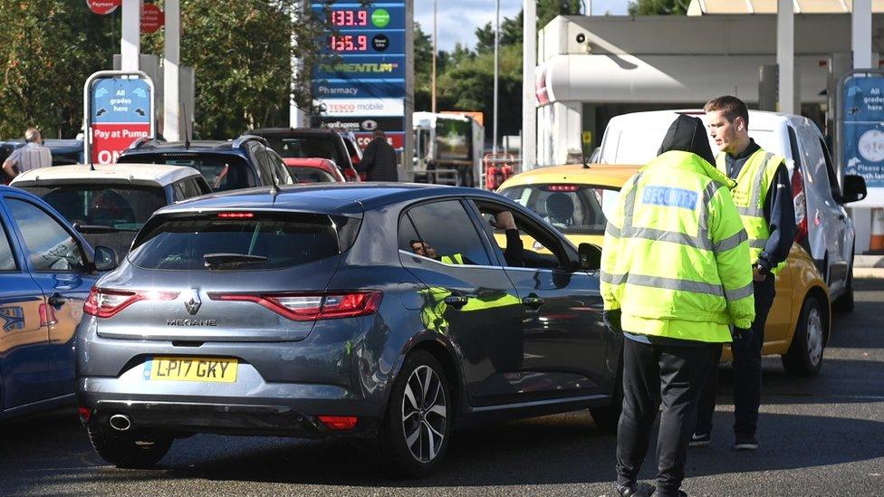 Cars queuing at a petrol station