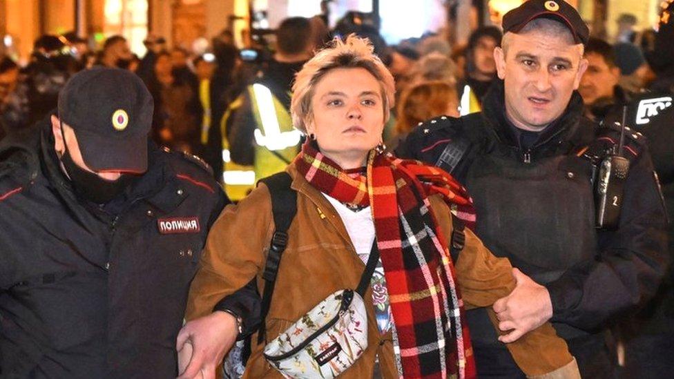 Police officers detain a woman in Moscow on 21 September 2022, following calls to protest against partial mobilisation announced by President Vladimir Putin