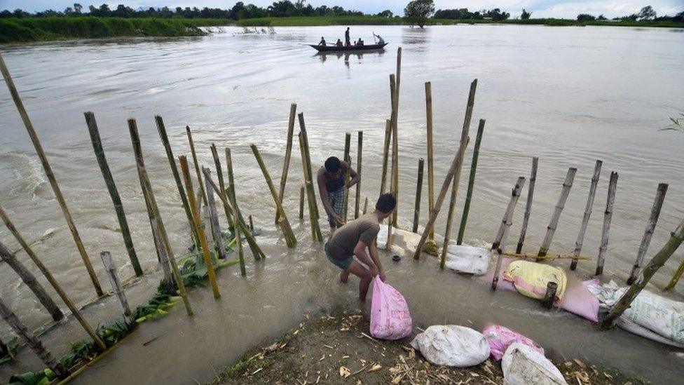 Villagers repairing an embankment with bamboo and sand bags which was washed away by flood waters in the flood affected Morigaon district of Assam state, India, 02 September 2015.