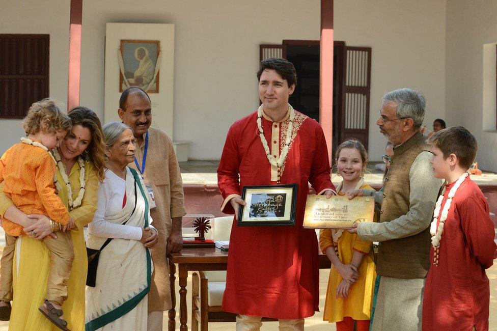 Mr Trudeau (C) poses with his family and a trustee of the Sabarmati Ashram in Ahmadabad, Gujarat.