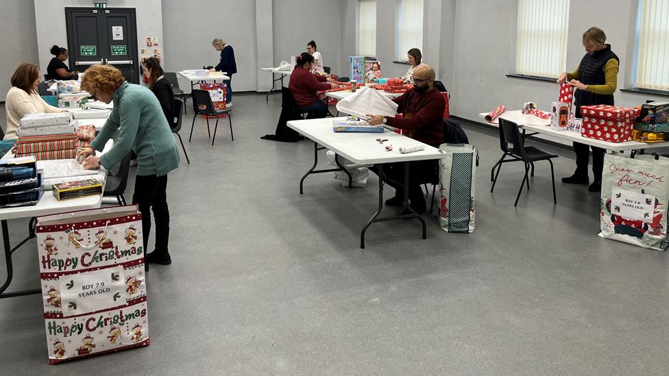 Volunteers wrapping presents