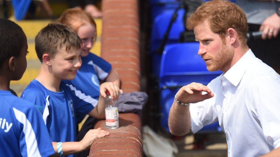 Prince Harry chats with schoolchildren during his visit to the Headingley Carnegie Stadium