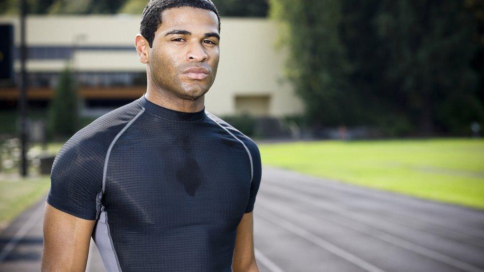 Man looking moody in lycra by racetrack