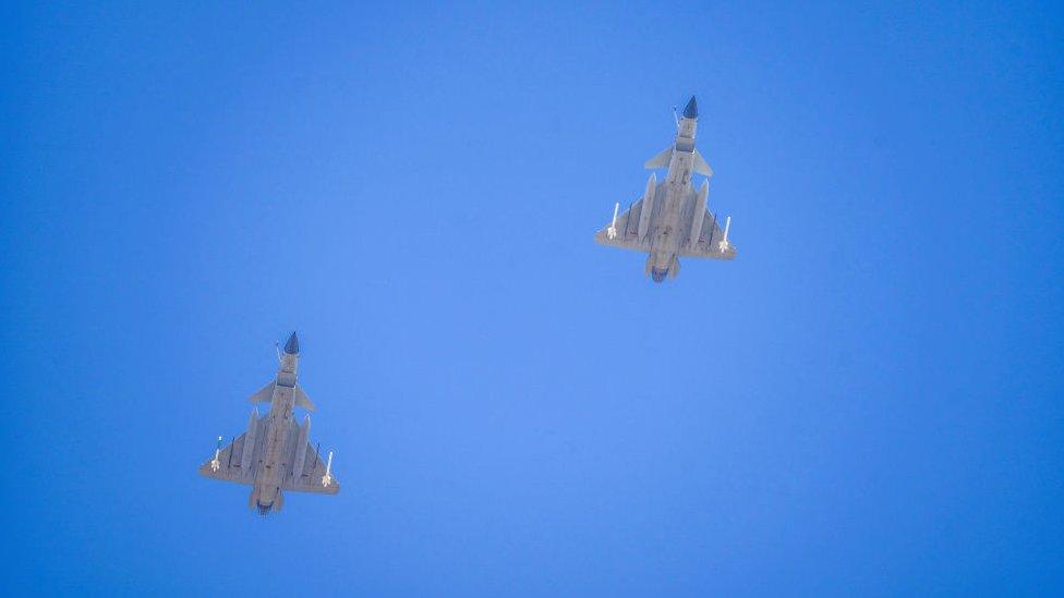 Two J-16 air fighters fly over a training base of PLA's naval aviation force in Ningbo in east China's Zhejiang province