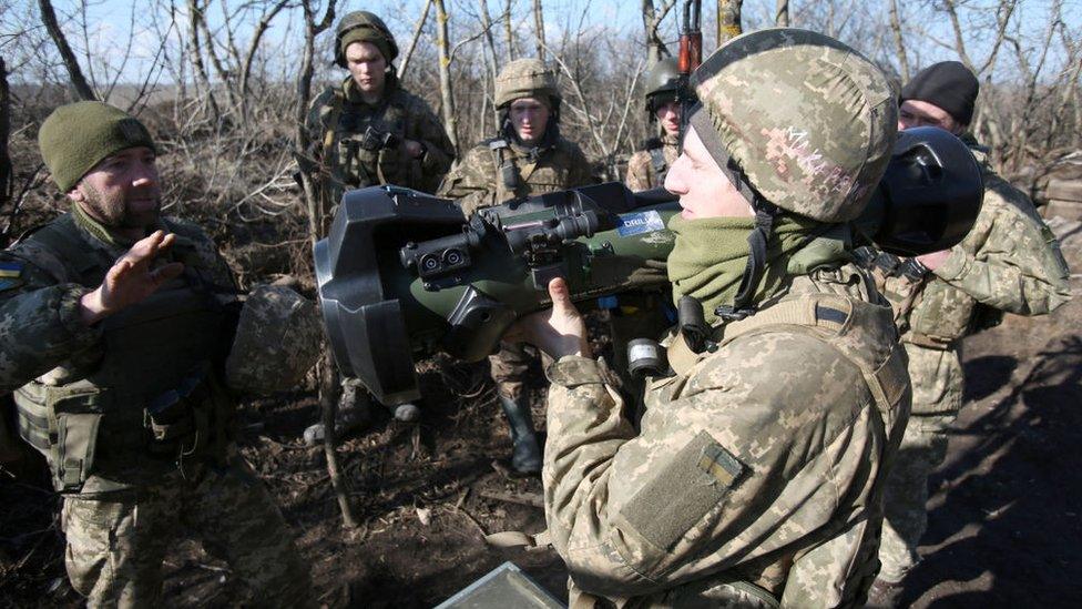 Servicemen of Ukrainian Military Forces on the front-line with Russia-backed separatists near Novognativka village, Donetsk region, examine a Swedish-British portable anti-tank guided missile NLAW that was transferred to the units as part of Britain's military-technical assistance, on February 21, 2022.