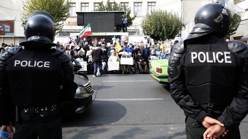 Iranian riot police keep watch as pro-government demonstrators gather in front of the German embassy in Tehran, Iran (1 November 2022)