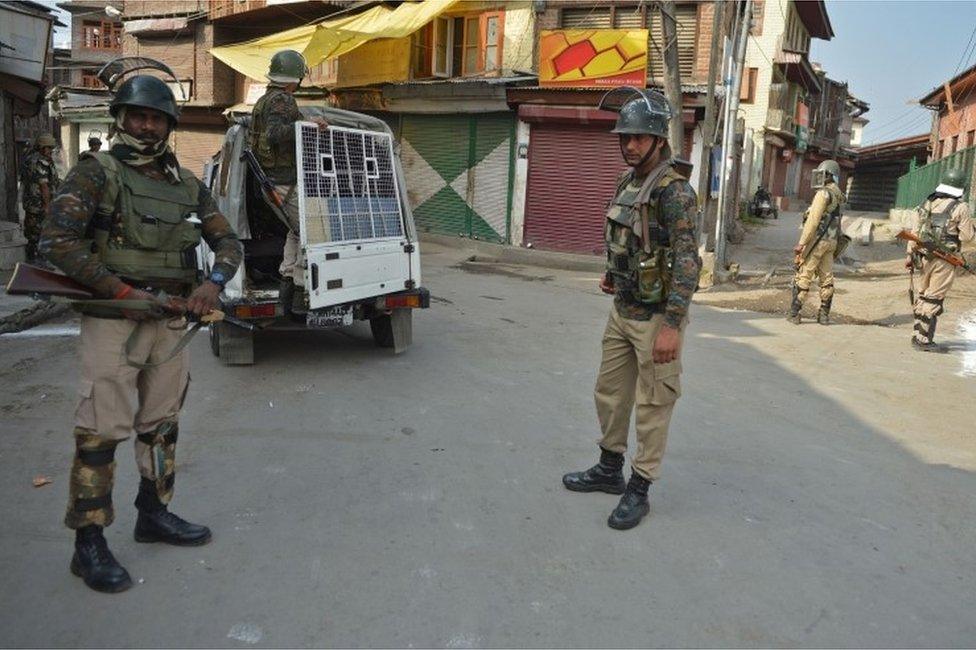 Indian government security forces stand guard near the mosque during the Muslim festival of Eid-ul-Adha during a curfew in Srinagar on September 13, 2016.