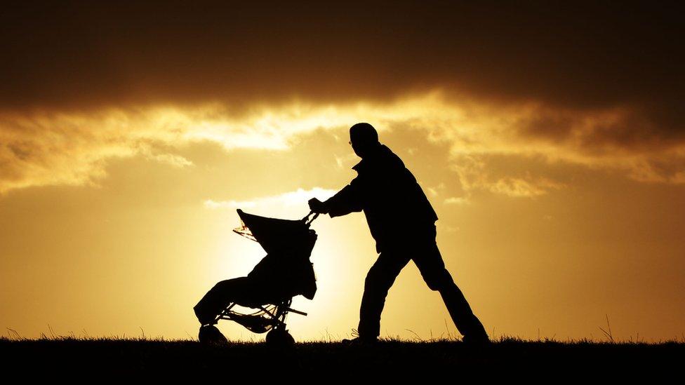 A single parent with a child in a pushchair