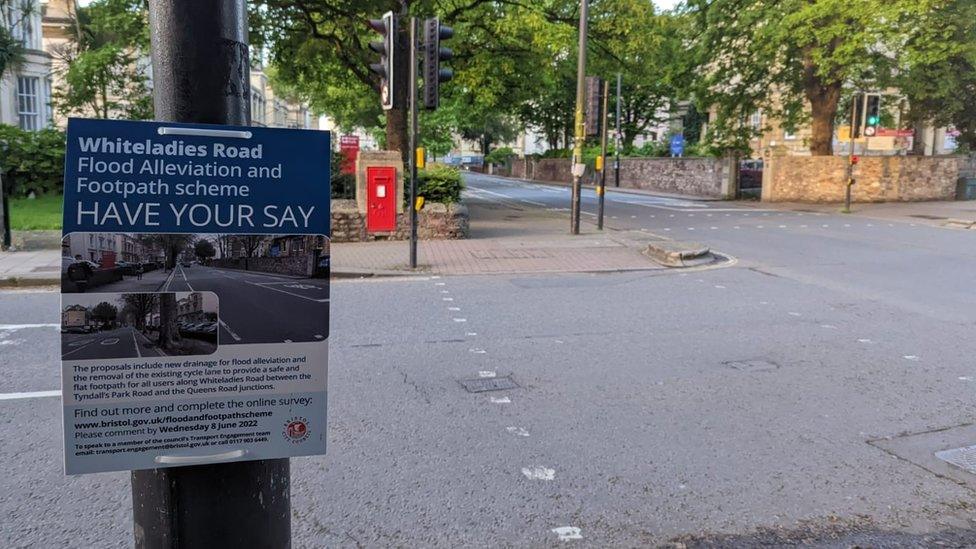 Sign about scheme attached to lamp post