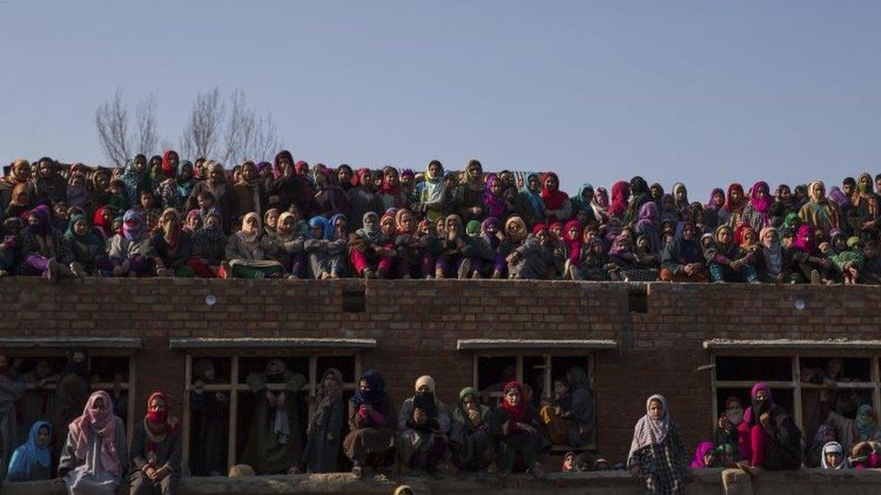 Kashmiris watch the joint funeral of two suspected rebels (12 February 2017)