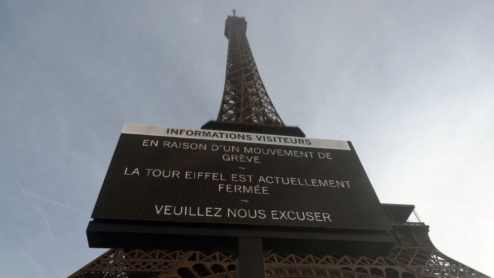 Eiffel Tower with a notice of closure in front