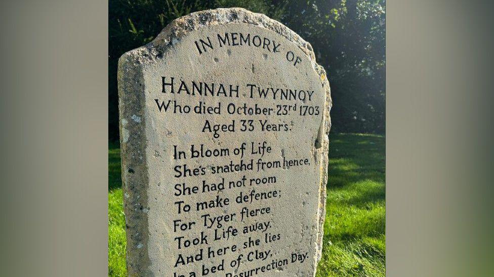 A close-up of the headstone detailing Hannah Twynnoy's date of death and showing a poem which includes the words, "For Tyger fierce Took Life away".