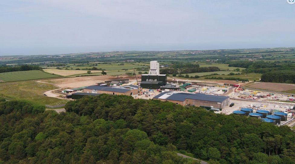 An aerial view of the Woodsmith Mine near Whitby. A large collection of industrial buildings set within a rural landscape.