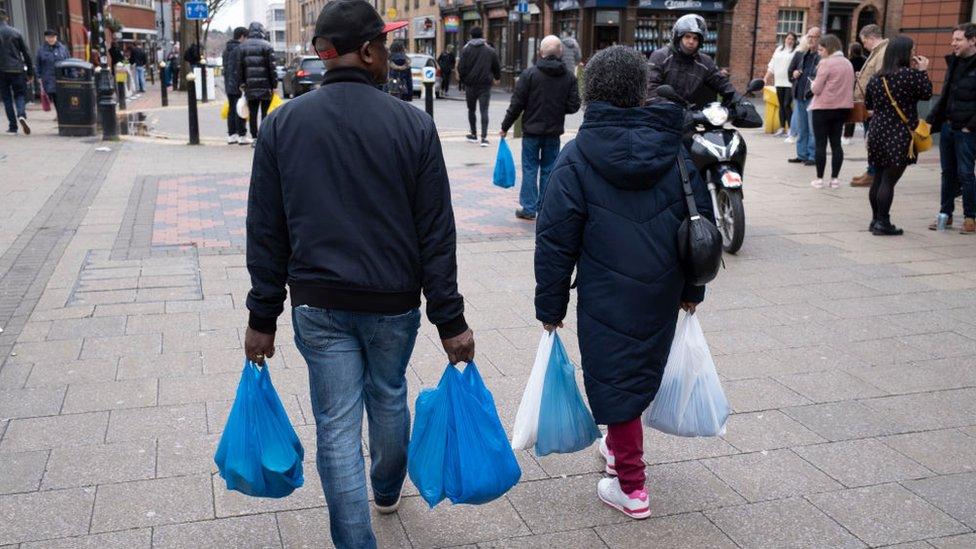 person with carrier bags